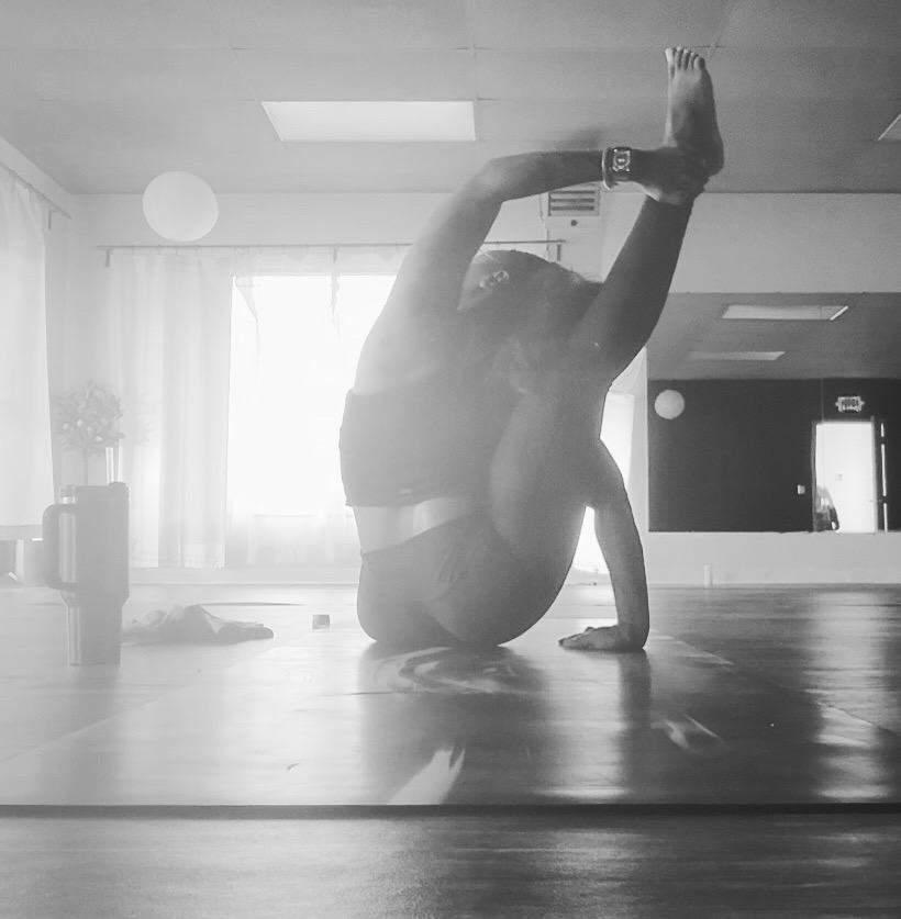 Brittany in a studio yoga pose, black and white